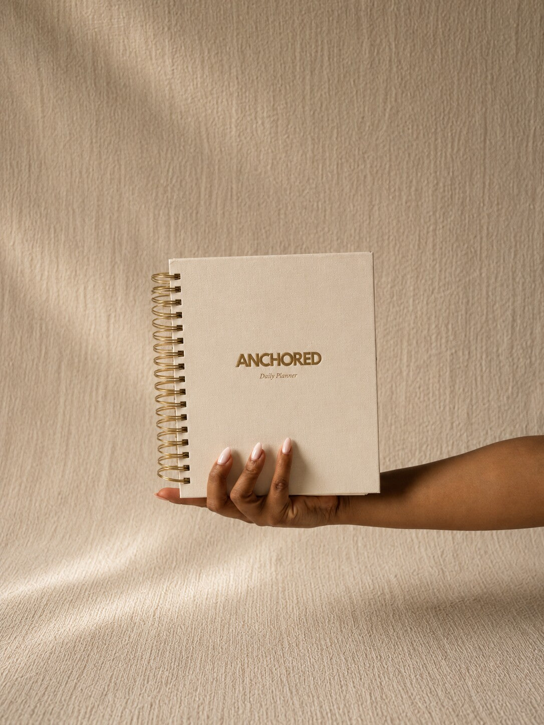 The Anchored Planner held in one hand, showing its size