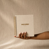 The Anchored Planner held in one hand, showing its size