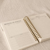 The Month in Focus spread with a monthly calendar, goals and a prayer list