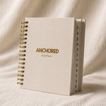 The Anchored Planner standing upright, showing the twelve monthly tabs